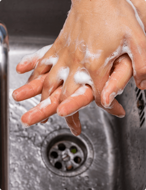 Hands washing over a sink